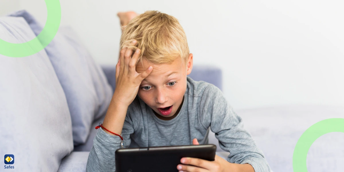 a young boy getting shocked at what he sees on his tablet