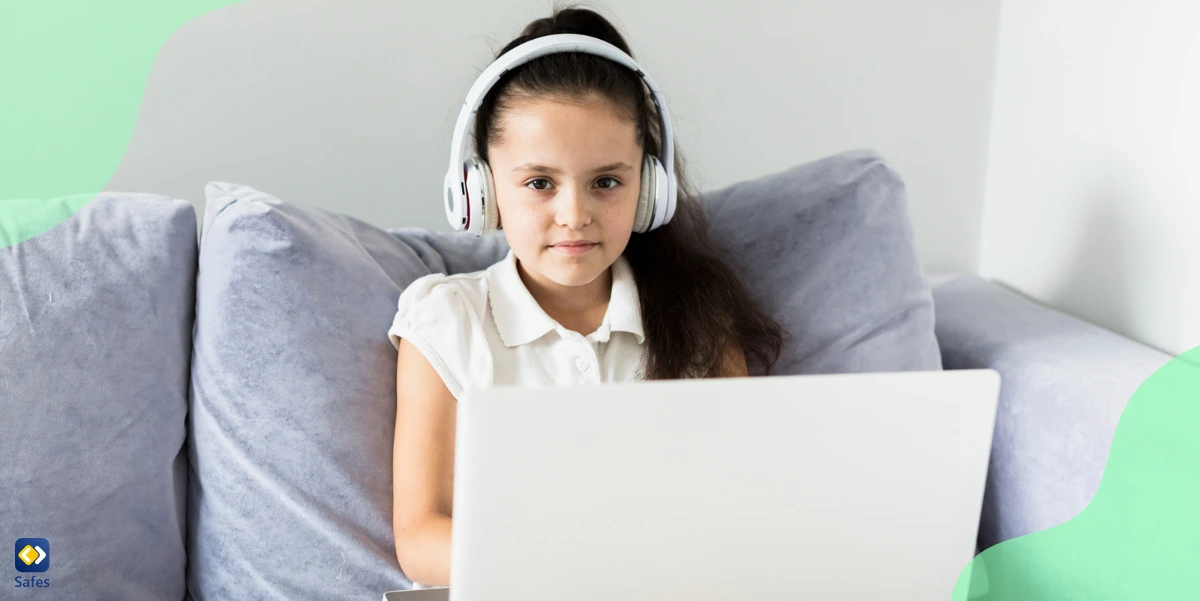 little girl using her laptop on sofa