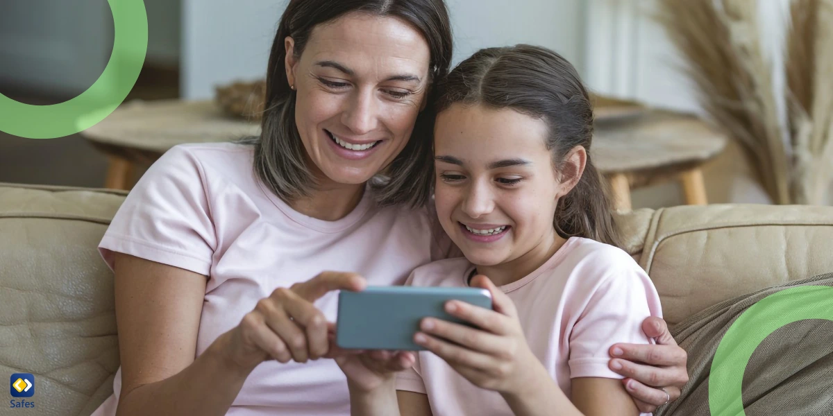 A mother and daughter looking at a smartphone together