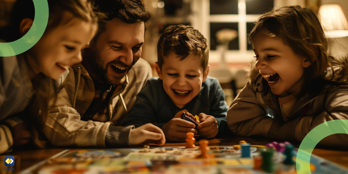 A father and his three children happily playing a board game together.