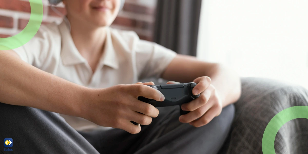 A teenage boy enjoying playing video games, holding a controller in his hand.