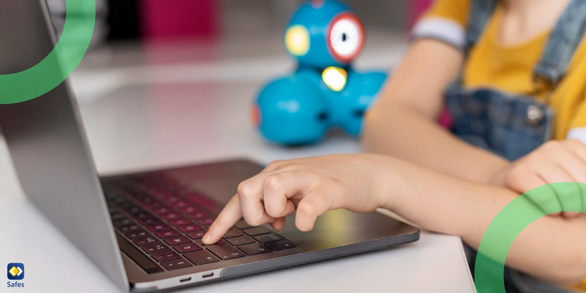 A child is seen using a laptop.