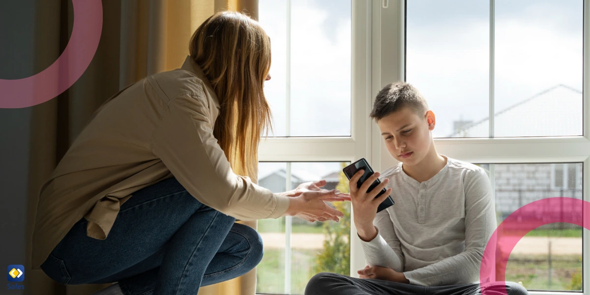 mother trying take their child’s phone who is sitting in front of a large window