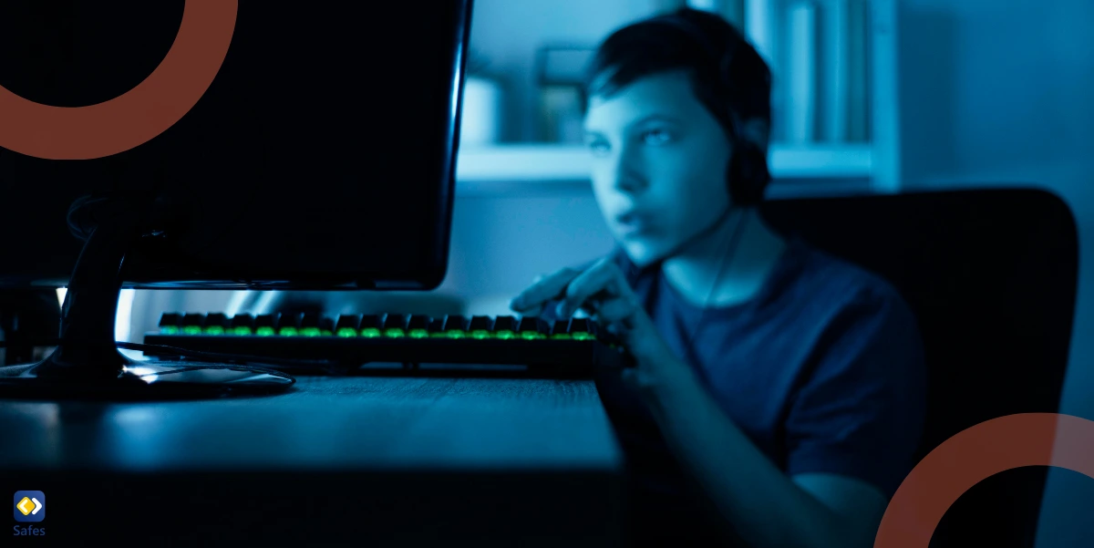 A young boy, seated in a dimly lit room, intensely focused on a computer screen while wearing headphones.