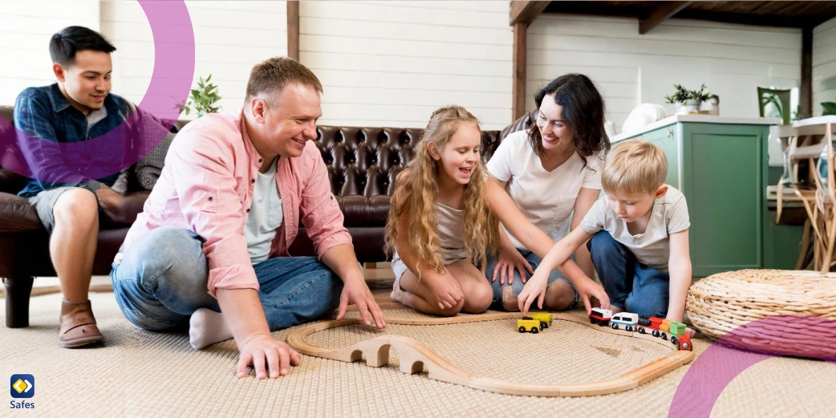 vierköpfige Familie spielt mit einer Holzeisenbahn