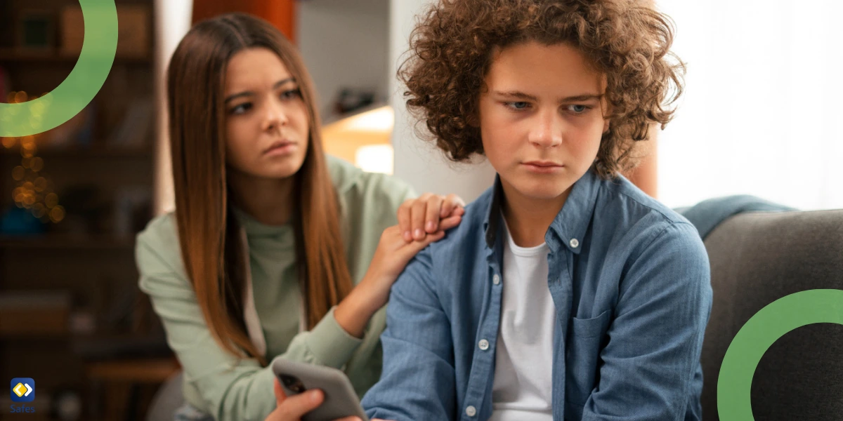 sad teen boy with phone in his hand and a friend supporting him with a hand on his shoulder