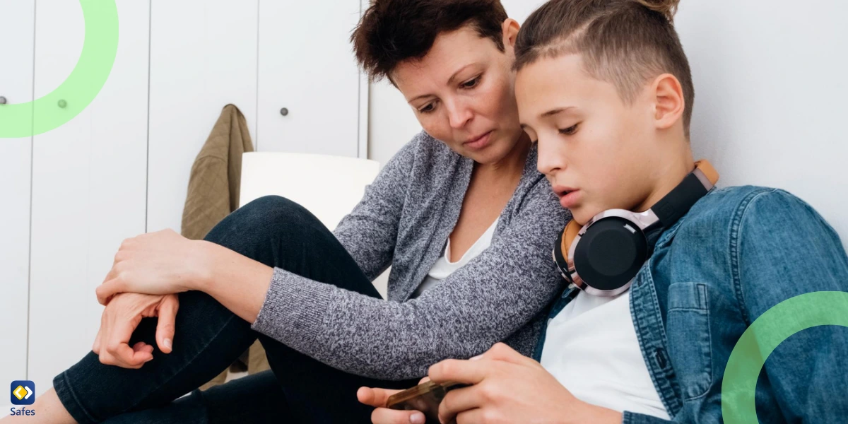 Middle aged mother spending time with teenager son together using mobile phone