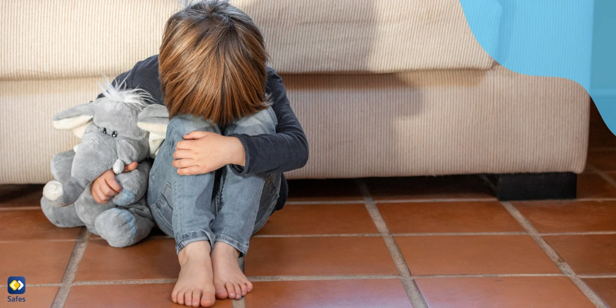 A depressed kid, leaning on a couch. Cyberbullying may often lead to isolation.