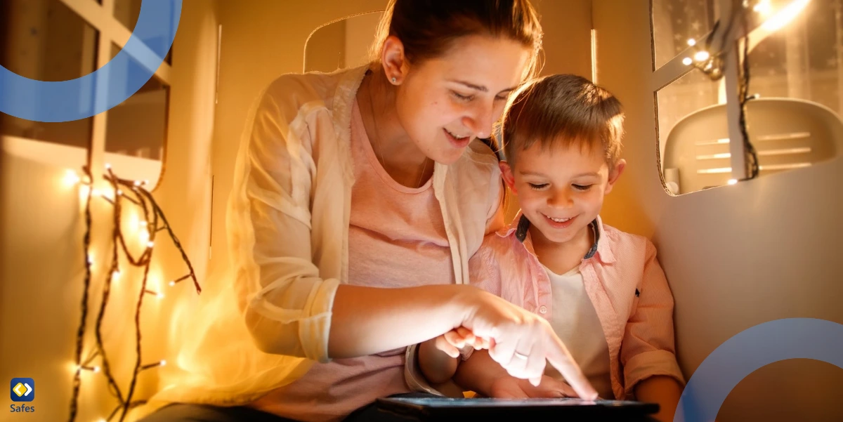 mother and son using a tablet in a small playhouse