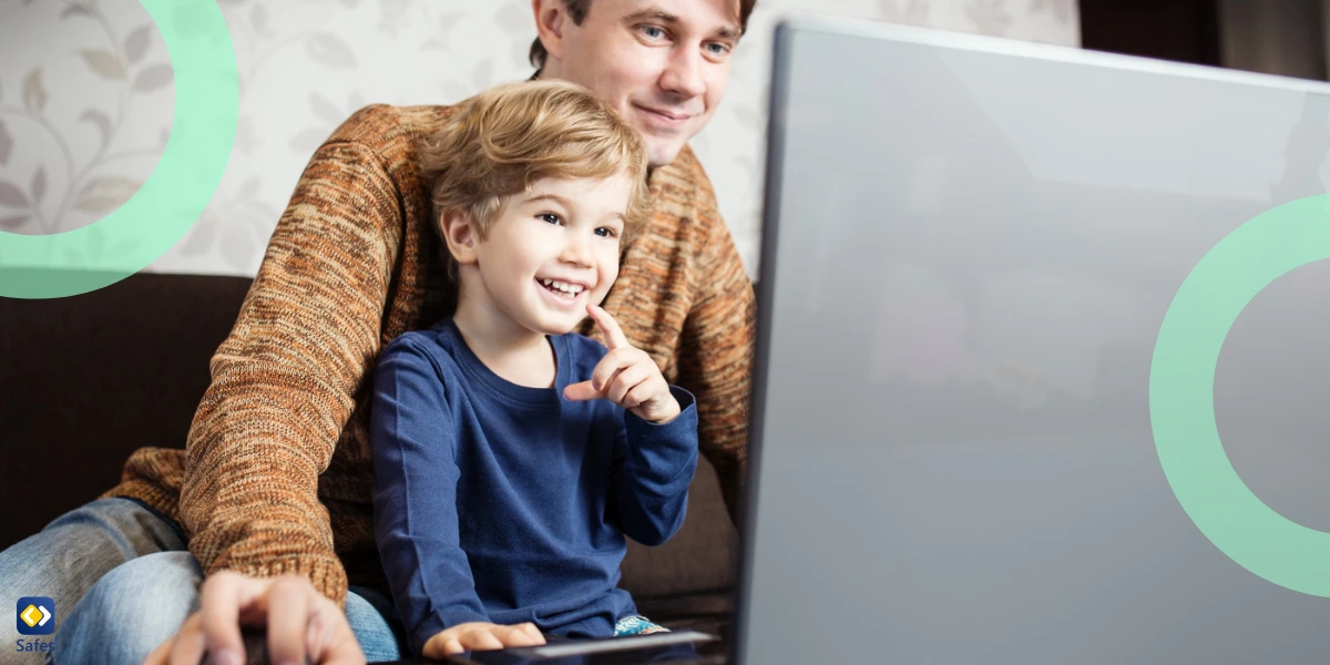 father and son using laptop