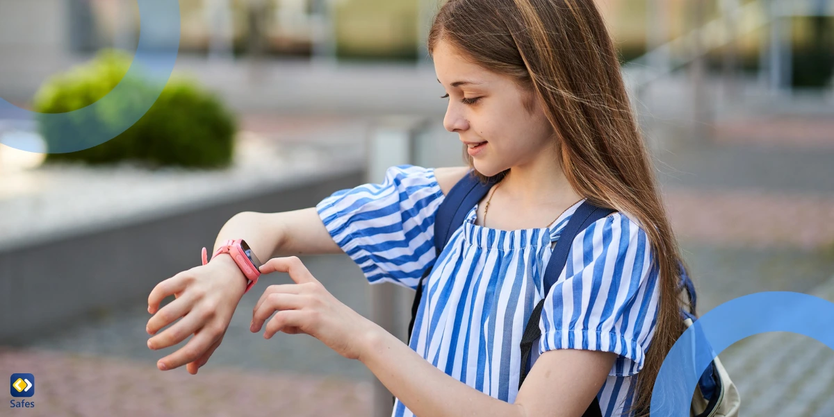 Happy young girl video calling her parents with her pink smartwatch on school premises