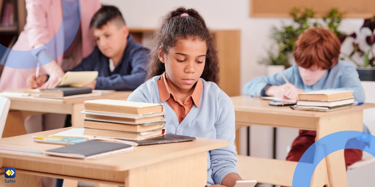 schoolgirl using smartphone and hiding it while teacher is helping other student