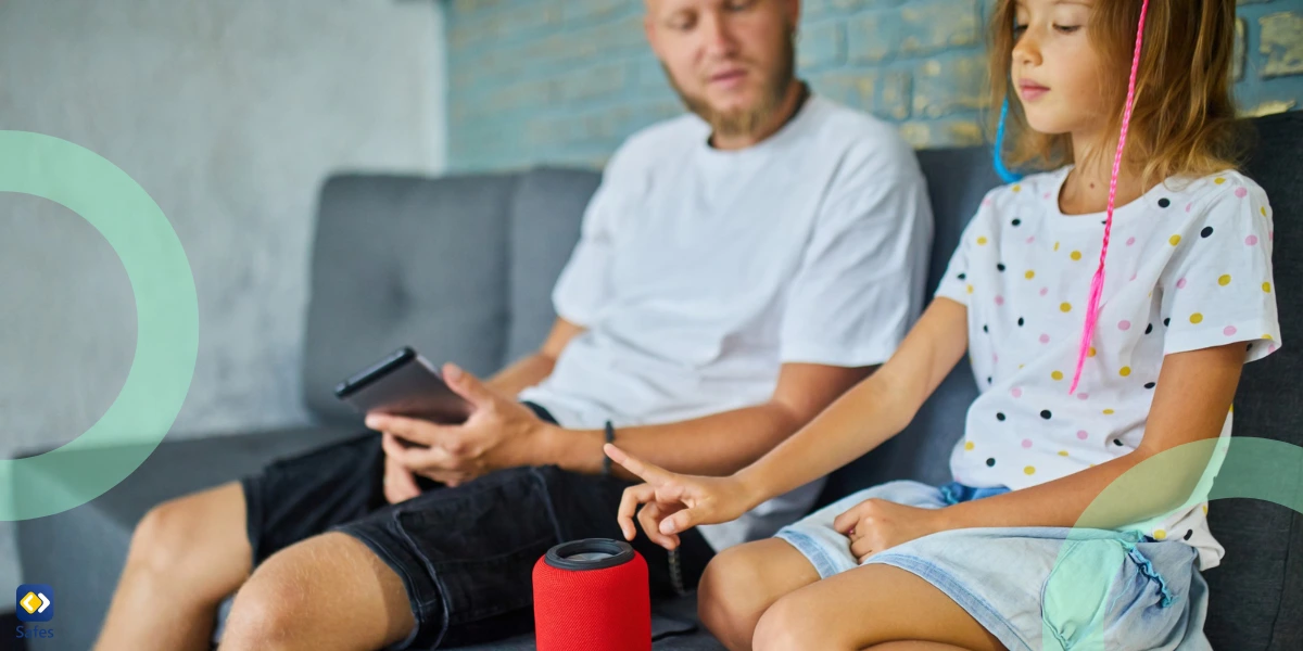 a father and daughter testing Alexa while sitting on a sofa at home