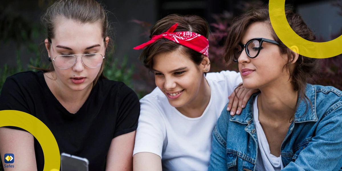 a group of friends chatting with their smartphones in the park.