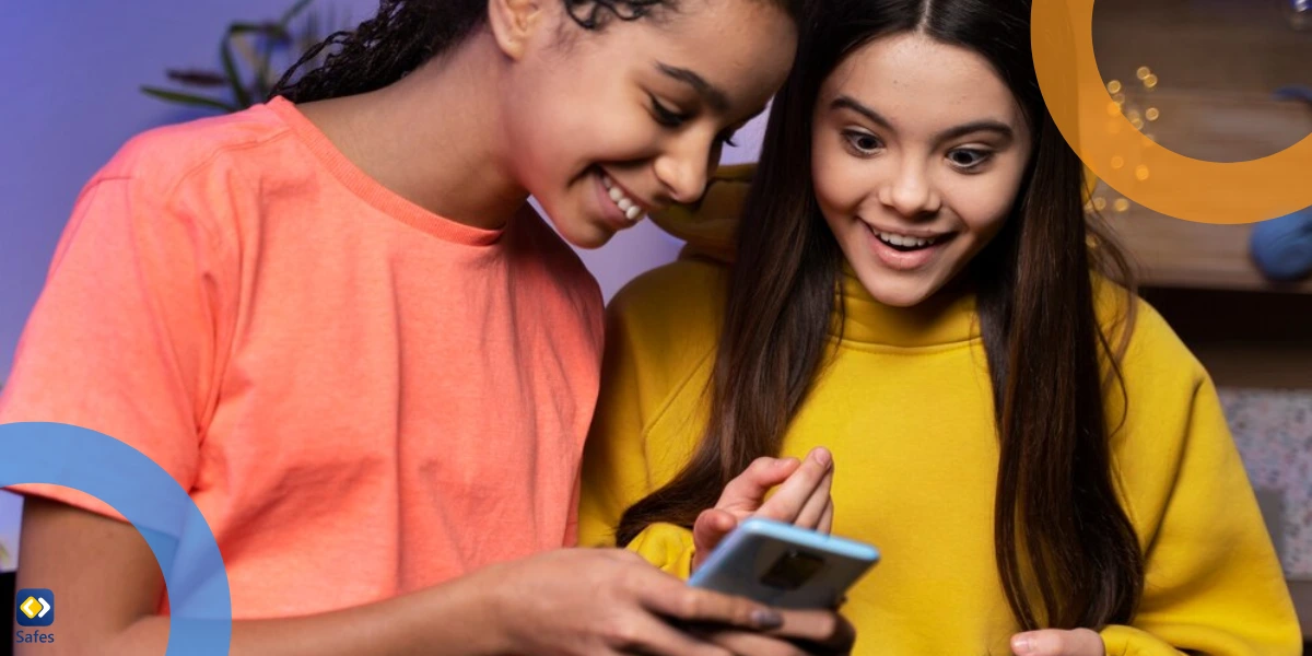 two teen girls smiling while using their phones