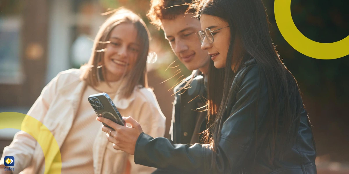 three teens looking at one smartphone