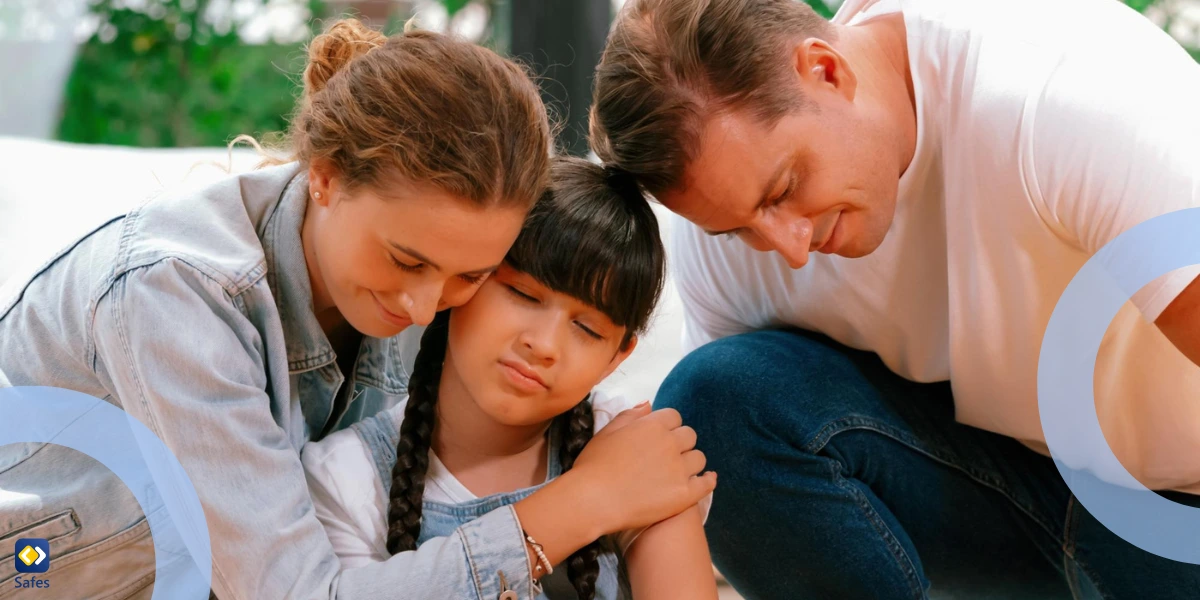 parents supporting and hugging their daughter