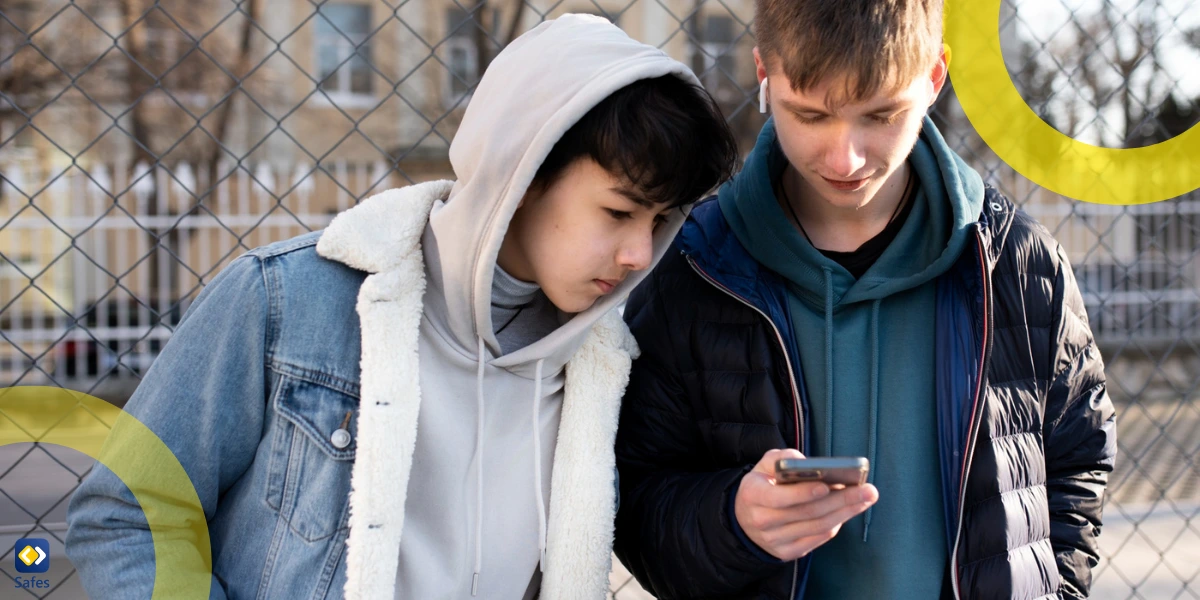 two teen boys checking a message on a smartphone