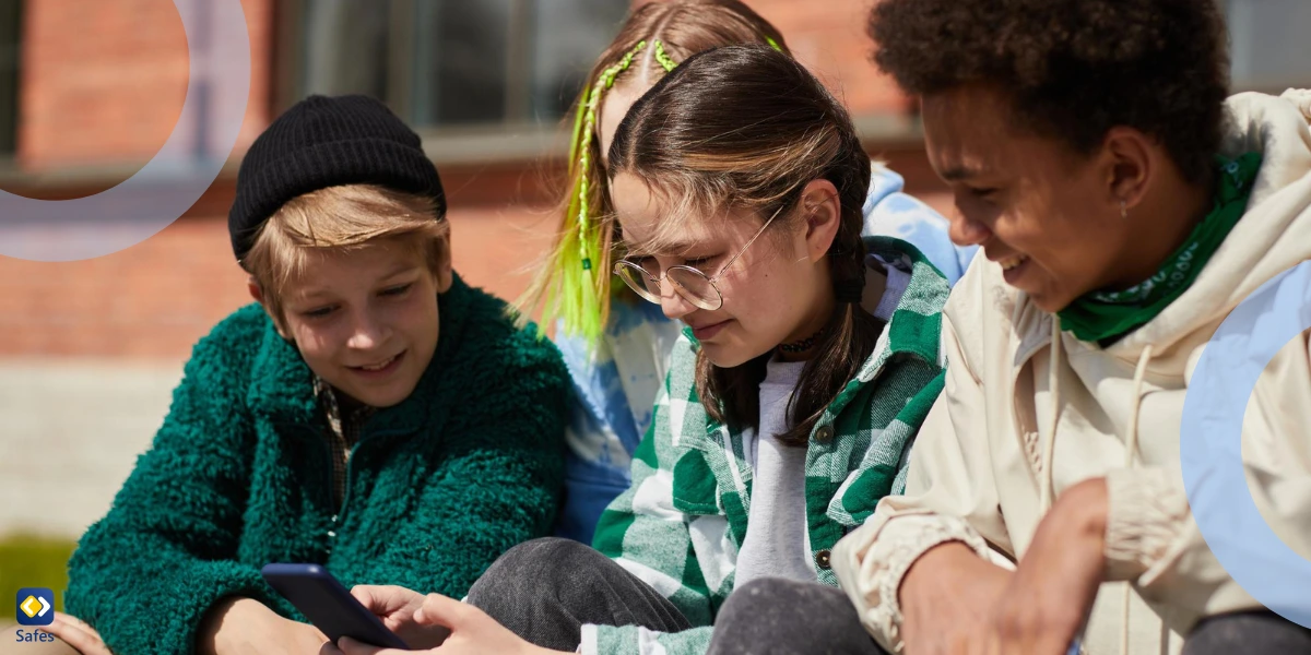 group of teens looking at one phone